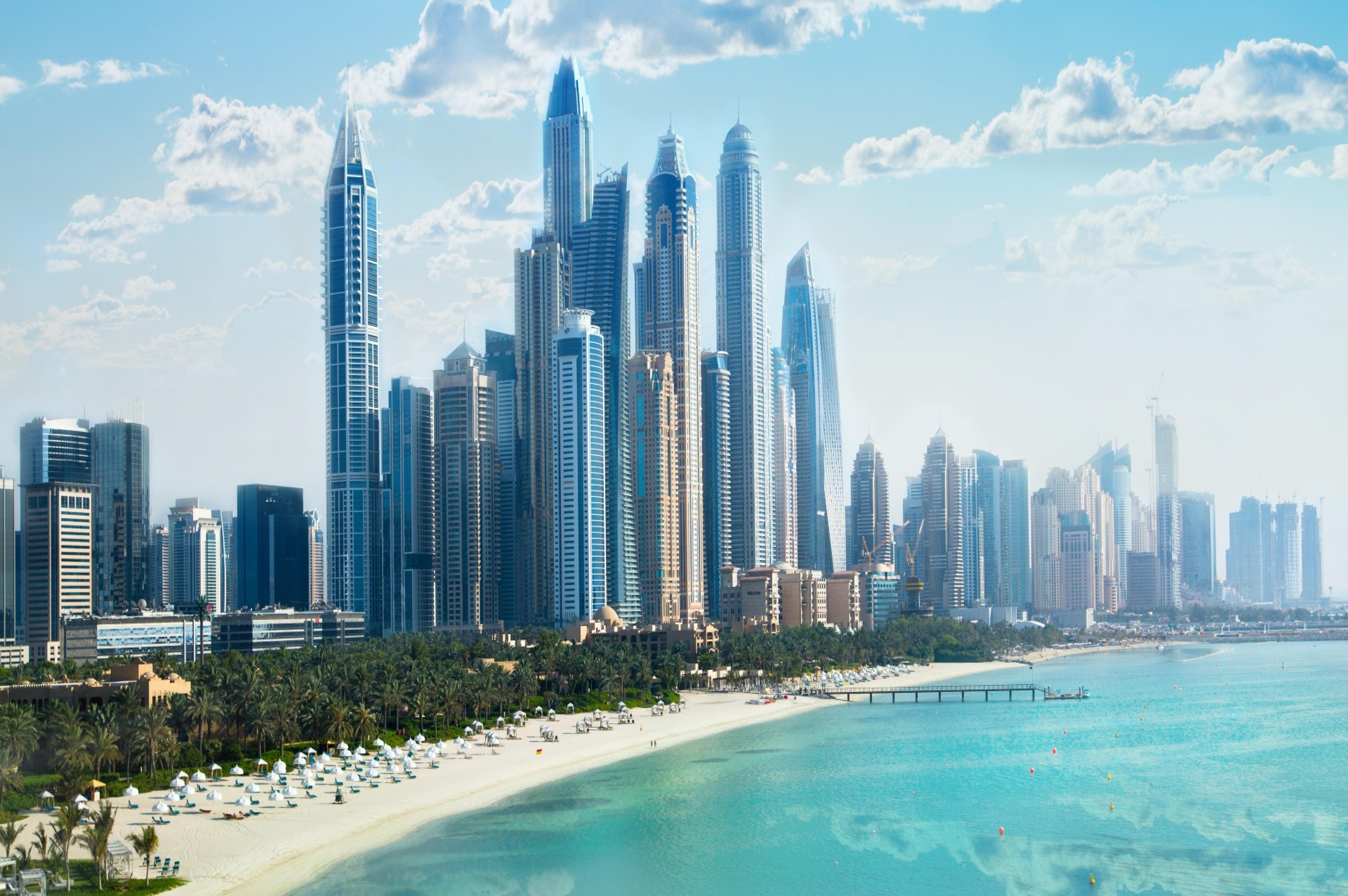 Dubai, UAE United Arabs Emirates. City of skyscrapers, Dubai marina in the sunny day with front line of beach hotels and blue water of Persian gulf